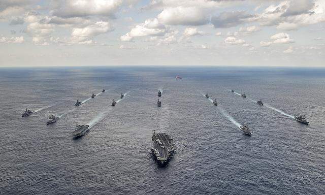 Handout photo shows U.S. Navy and Japan Maritime Self-Defense Force ships steaming in formation during their military manoeuvre exercise known as Keen Sword 15 in the sea south of Japan