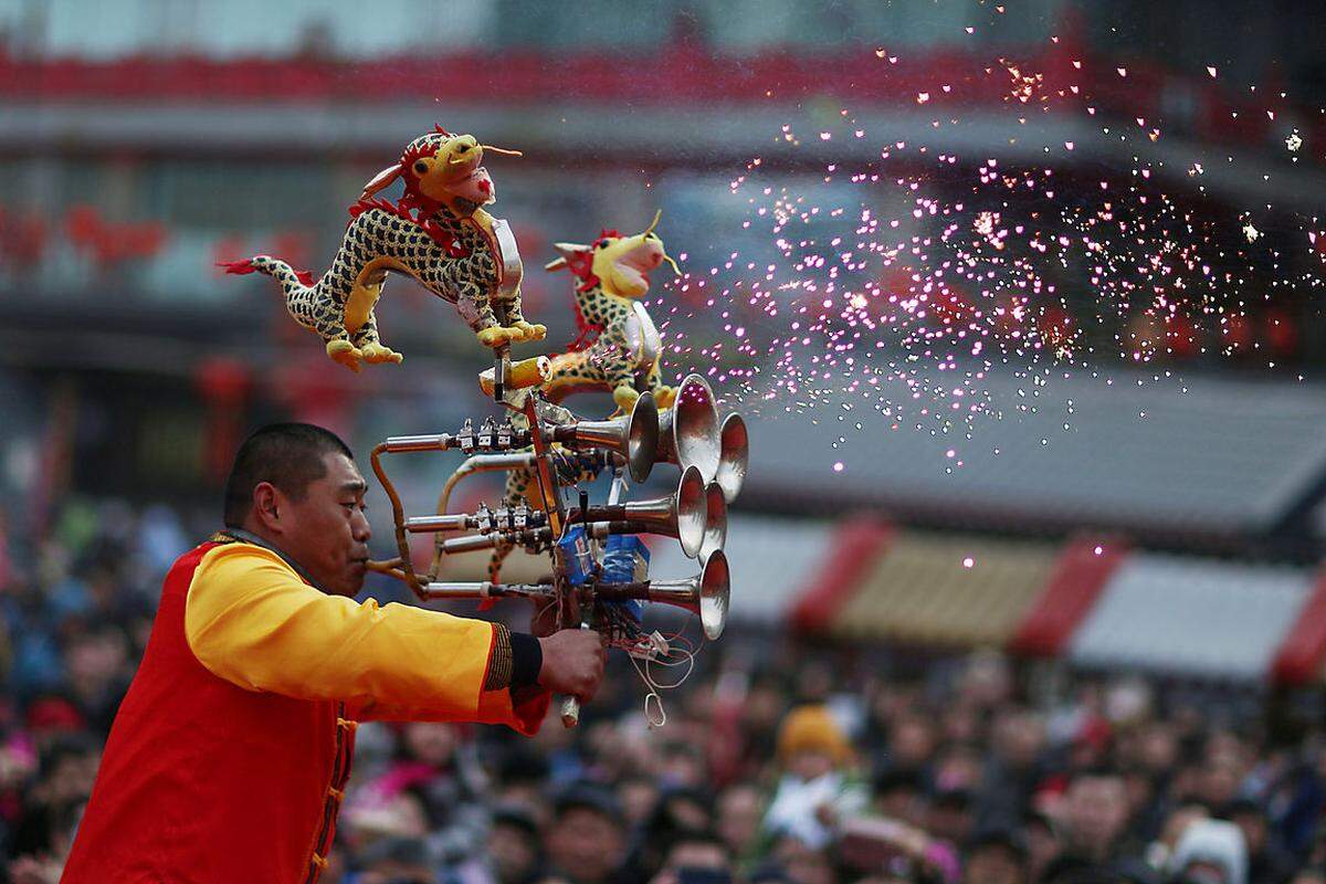 Auch in der nordchinesischen Stadt Shenyang ging es ähnlich bunt zu: Ein Musiker begeisterte mit seinem Instrument die Zuseher bei einem Jahrmarkt.