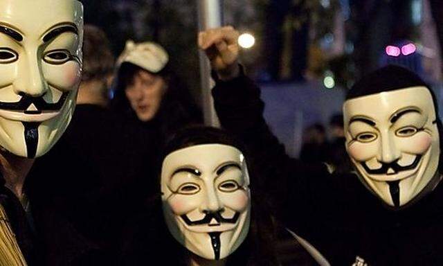 Occupy Wall Street protestors wearing Guy Fawkes masks commonly associated with the hacker group Anon