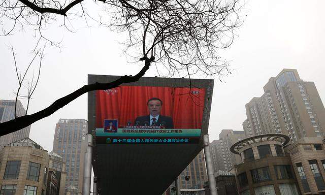 A giant screen shows Chinese Premier Li Keqiang delivering a speech during the opening session of the National People´s Congress (NPC) at the Great Hall of the People, in Beijing