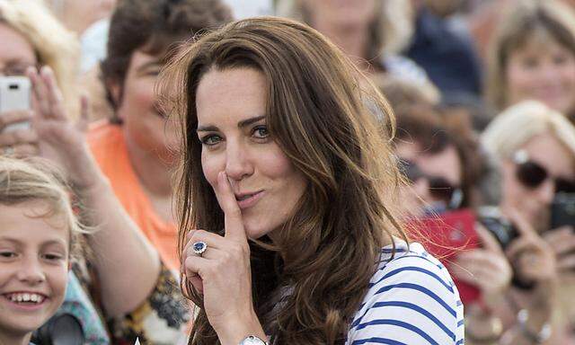 Britain´s Catherine, Duchess of Cambridge reacts a she arrives to travel on an America´s Cup yacht in  Auckland Harbour