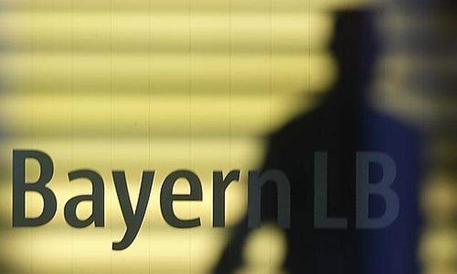 File photo of an employee of the Bavarian public sector bank BayernLB walking near the banks logo ins logo in