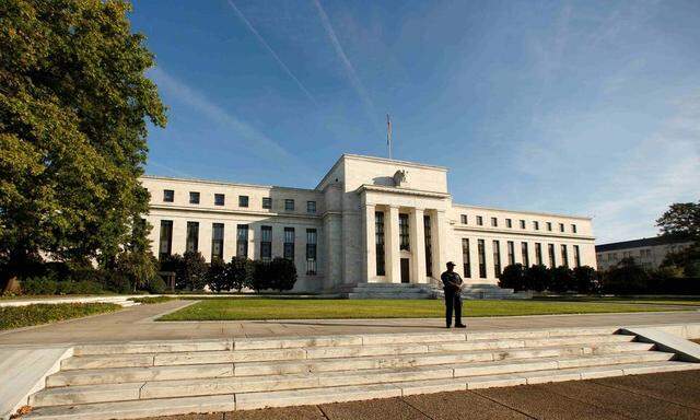 A police officer keeps watch in front of the U.S. Federal Reserve in Washington