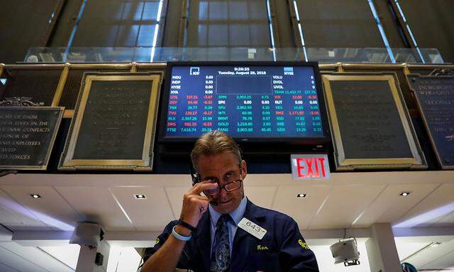 Traders work on the floor of the NYSE in New York