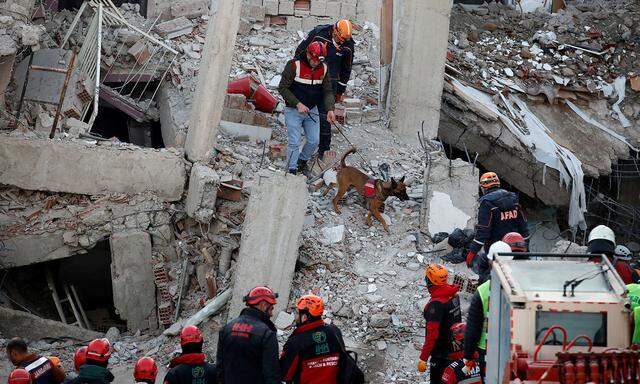 Bergungsteams suchen in eingestürzten Häusern nach Überlebenden.